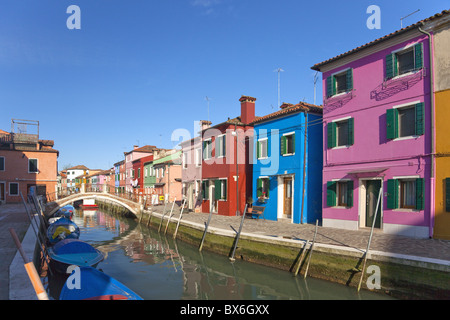 Brightly coloured houses along canal in Burano town, Venice Lagoon Island, Veneto, Italy, Europe Stock Photo