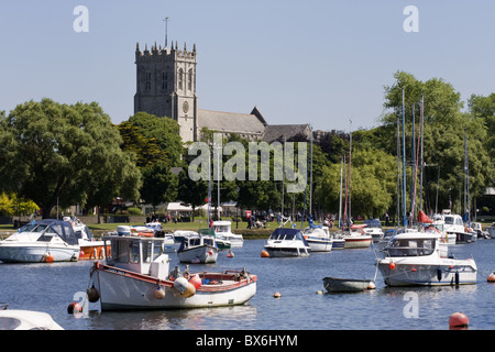 Christchurch Priory and pleasure boats on the River Stour, Dorset, England, United Kingdom, Europe Stock Photo