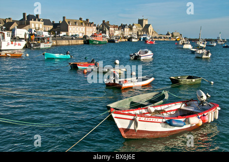 Harbour and fishing boats with houses and church in the background, Barfleur, Manche, Normandy, France, Europe Stock Photo