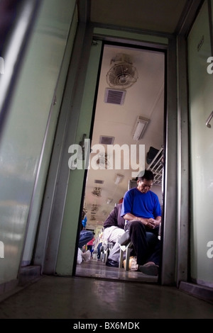 People are traveling on a Bangkok bound passenger train in Ubon Ratchathani Province, Thailand. Stock Photo