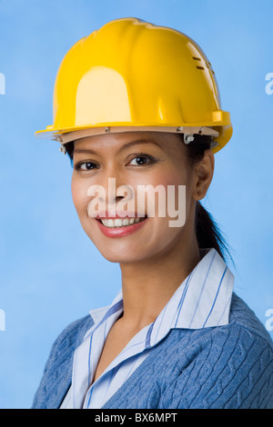Portrait of pretty female with helmet on head looking at camera Stock Photo