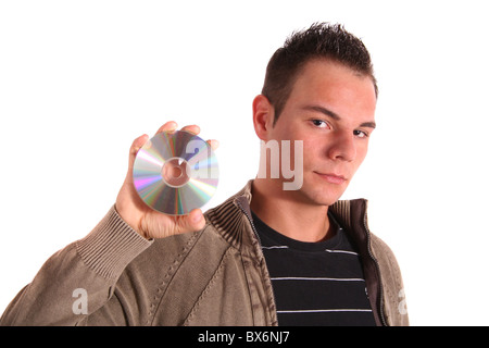 A handsome young man holding a cd or dvd. Stock Photo