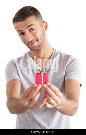 A handsome man holding a small red present. All isolated on white background. Stock Photo