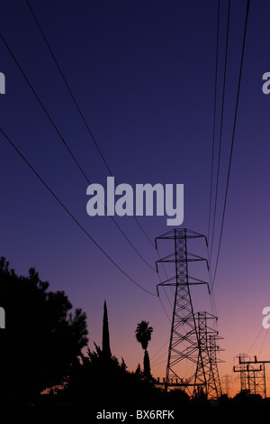 Electrical power lines silhouetted at sunset Stock Photo - Alamy