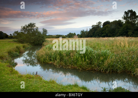 The River Windrush meanders through the water meadows just outside of the Cotswolds town of Burford, Oxfordshire, England. Stock Photo