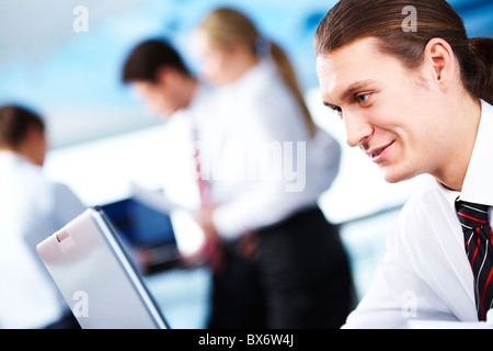 Portrait of busy chief working on background of communicating partners Stock Photo