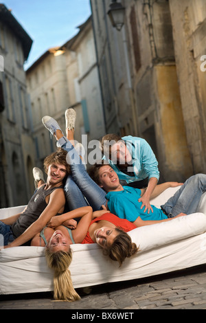 Young group portrait sit on couch street Stock Photo