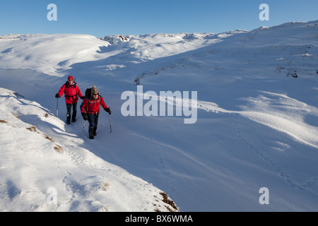 2 male walkers in winter on Kinder Scout in the Dark Peak part of the ...