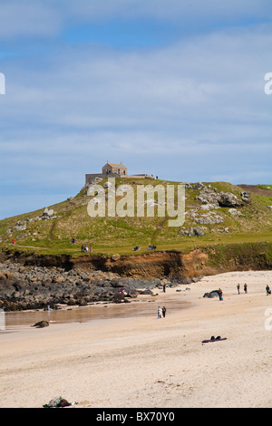 Shot of St Nicholas Chapel shot from Portmeor beach in St Ives Cornwall England with the sea on the left in the summer Stock Photo