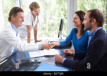 Doctors with patients, in office Stock Photo