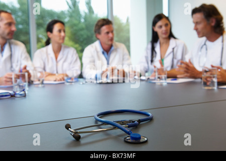 Doctors meeting, stethoscope on table Stock Photo