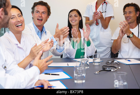 Doctors applauding their chief Stock Photo