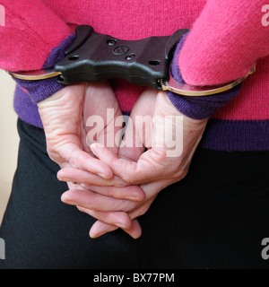 Woman locked in police issue handcuffs holding drugs Stock Photo - Alamy