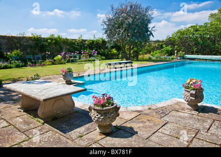 An outdoor swimming pool in an English country summer garden Stock Photo