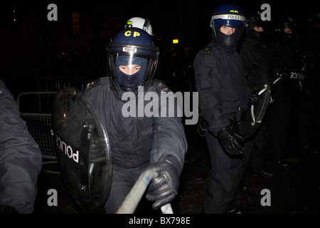 Riot cop grabs a barricade during student demo in Whitehall Stock Photo