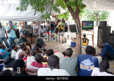 People crowd around several television sets to watch the World Cup final on July 11, 2010 in Port-au-Prince, Haiti. Stock Photo