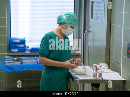 Surgical nurse documenting an operation, Essen, Germany