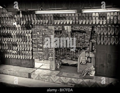 Arabian shoes on sale in a traditional souk in old Dubai, UAE. Stock Photo