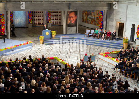 Chinese dissident Liu Xiaobo was awarded the Nobel Peace Prize in absentia on December 10, 2010, at a solemn ceremony held at Oslo City Hall. Thorbjørn Jagland, chairman of the Norwegian Nobel Committee opened the ceremony of music and readings with a presentation speech explaining why the award was 'necessary and appopriate,' despite strong reactions from the Chinese government. Seated on the dais were four members of the Nobel Committee and its permanent secretary. An additional chair, which remained empty, and an enlarged portrait, represented Liu Xiaobo himself. (Photo by Scott London) Stock Photo