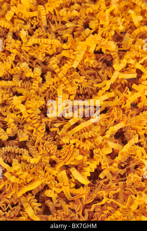Detail of orange shredded packaging paper - background Stock Photo