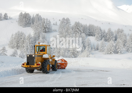 Big machine cleaning the snow from the road Stock Photo