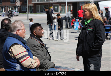 Two men and woman talking during neighbourhood festivities in Amsterdam Nieuw West Stock Photo