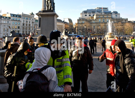 Metropolitan Police officers detain a young person in Trafalgar Square in London. Stock Photo