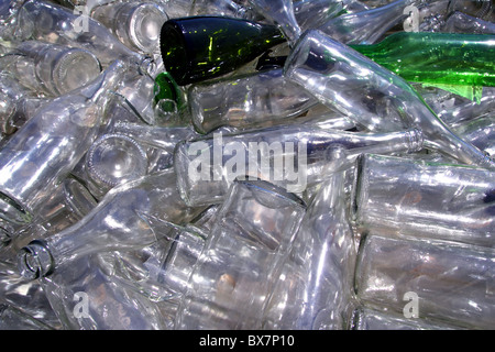 ecological recycling glass bottles in messy container Stock Photo