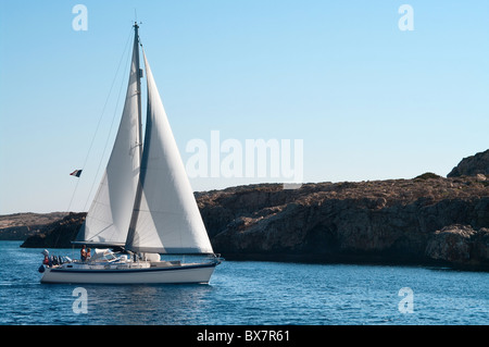 Yacht around the rocky shores of the Mediterranean island of Cyprus Stock Photo