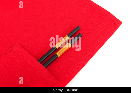 a pair of chop sticks in red placemat Stock Photo