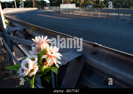 Flowers on roadside ground of  Rome Italy street, as memorial of fatal accident victim. Stock Photo