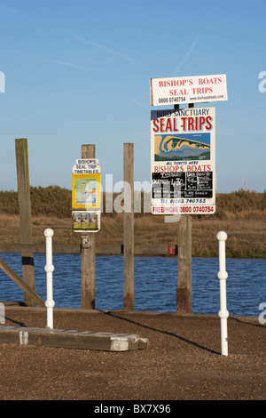 Signs for Seal Trips at Blakeney Quay on the North Norfolk Coast Stock Photo