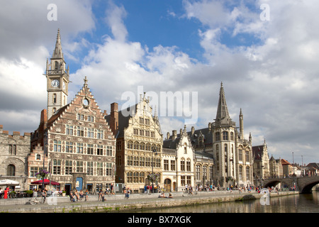 Ghent Graslei on the waterfront in Belgium with tourists sunbathing Stock Photo