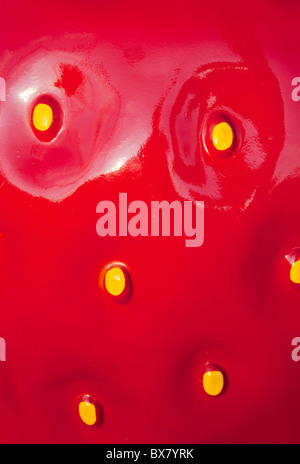Red bumpy surface with yellow dots Stock Photo
