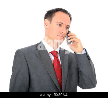 Serious businessman making a phone call. All on white background. Stock Photo