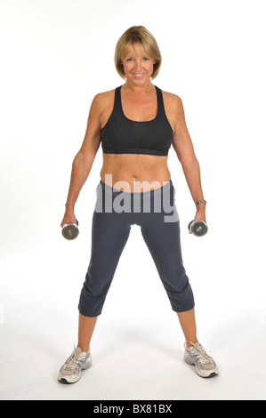 50 yr old woman posing with dumb bells Stock Photo - Alamy