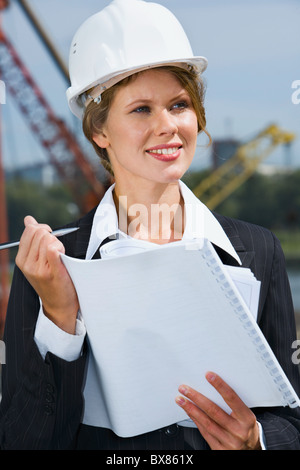 Portrait of beautiful engineer holding architectural project and pen Stock Photo