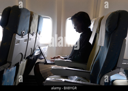 An African passenger using laptop computer inside an Ethiopian Airlines plane Stock Photo