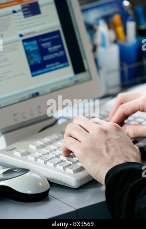 Close up of hands on a keyboard of a laptop Stock Photo
