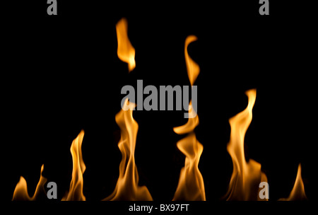 Row of flames from a fireplace on a black background Stock Photo