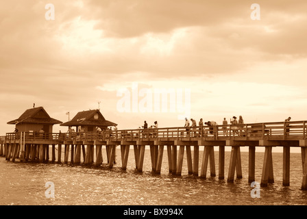 Naples Florida fishing pier at sunset with tourists visible Stock Photo