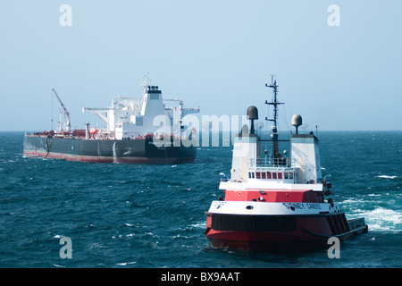 Tug boat towing an oil tanker vessel.  Offshore Rio de Janeiro, Brazil. Stock Photo