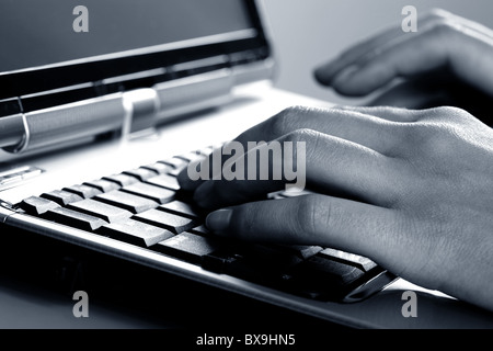 Image of female hands typing a text on the laptop Stock Photo