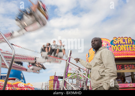 Fair with attractions in the Semana Negra cultural festival, featuring the largest traveling ferris wheel in Europe. Stock Photo