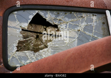 Close-up view of shattered windshield on rusty old truck. Stock Photo