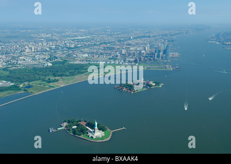 Aerial view of Liberty statue, Ellis island, Hudson river and back Jersey city during hot summer, New Jersey state, USA Stock Photo