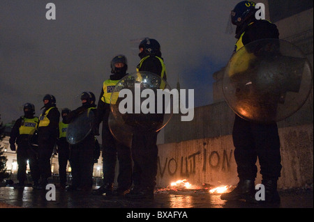 Metropolitan police officers, most in full riot protective uniform in Parliament Square and Trafalgar square. Stock Photo