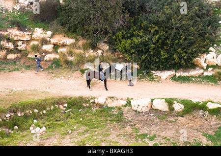 Children with their horse in Gai Ben-Hinnom ( Ben Hinnom valley ) in Jerusalem. Stock Photo