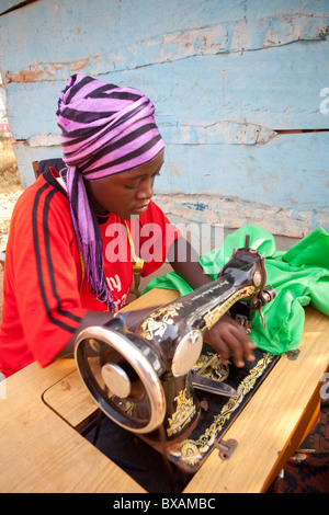 A tailor (Amina Mbawaire) at her sewing machine in Iganga, Eastern Uganda, East Africa. Stock Photo
