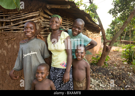 Smiling children stand outside a house in Igamba village, Iganga District, Eastern Uganda, East Africa. Stock Photo